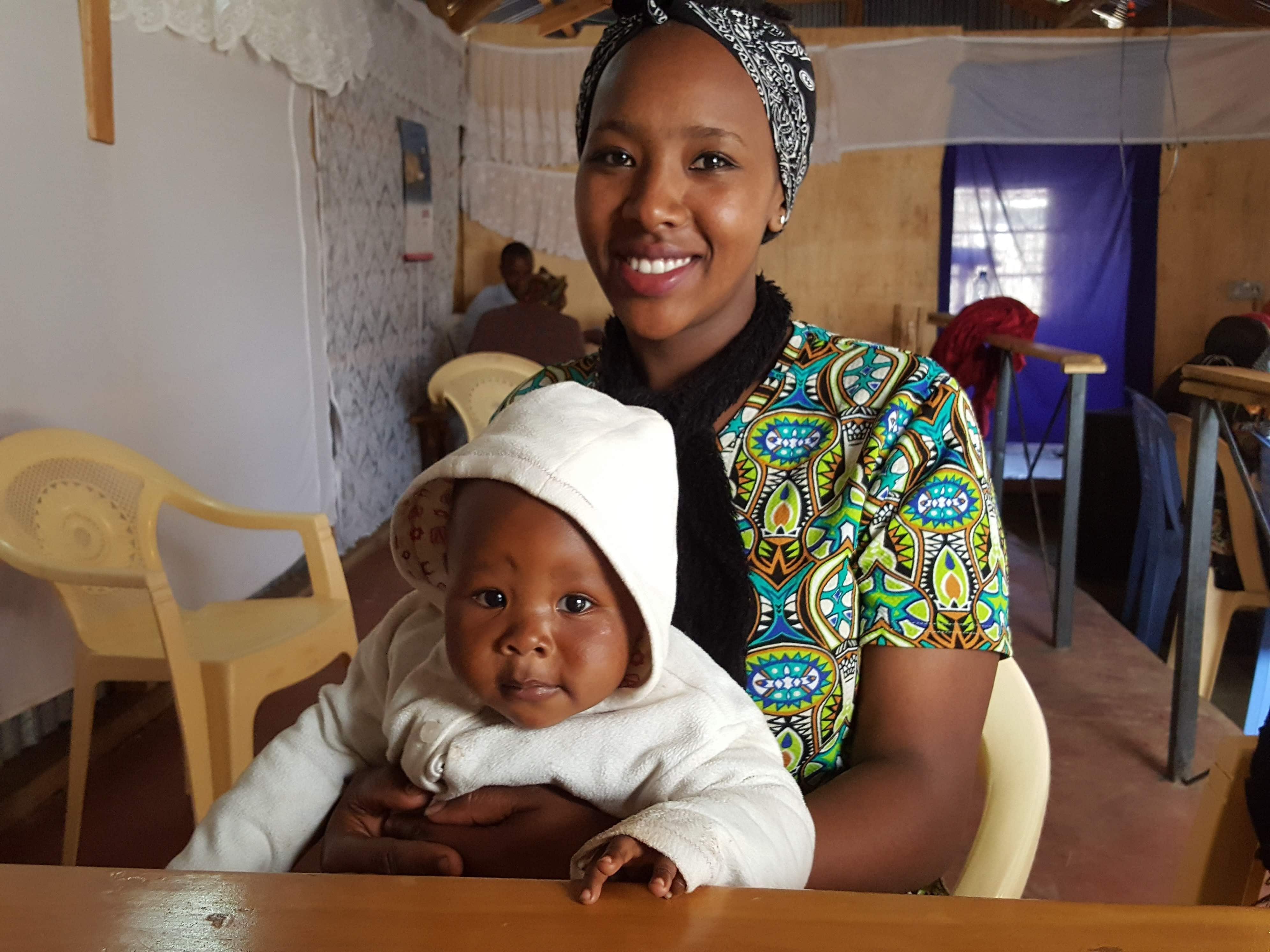 A Smiling Woman With Her Child